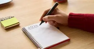 Writing 2026 resolutions in notebook