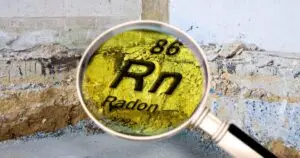 Radon being detected under a magnifying glass in a home