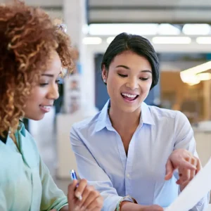 Female Human Resources Director reviewing health care options and insurance plans with a female employee