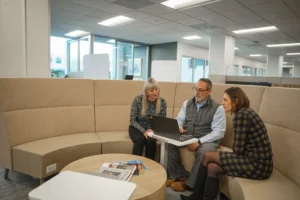 Picture of employees meeting together in the collaboration lounge at the Walsh Buffalo office